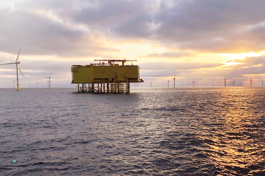 Onshore converter platform in the sea with wind turbines