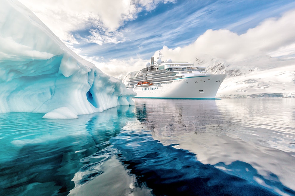 Mega yacht in sea ice with iceberg